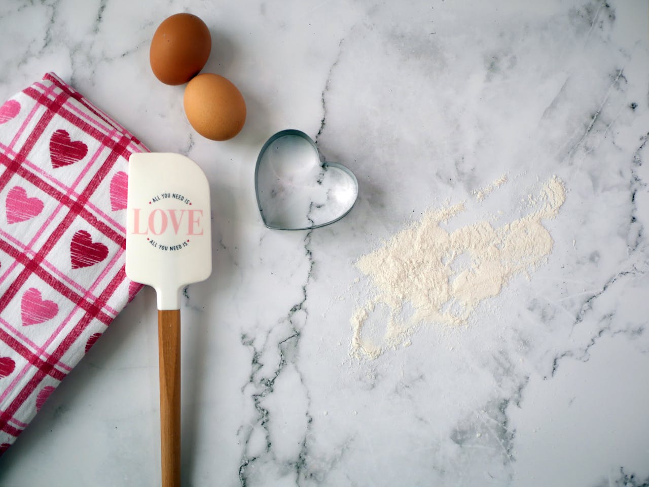 Crafting Captivating Headlines: Your awesome post title goes here Flat lay of baking essentials with heart motif on marble surface, featuring eggs, flour, and utensils.